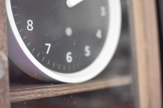 A photograph of an Echo Wall Clock inside a fireplace TV stand