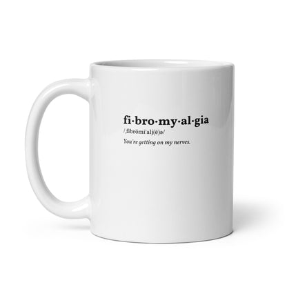 up close image of a white mug that reads "fibromyalgia / you're getting on my nerves"